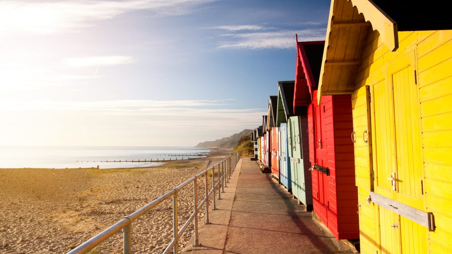 pretty coloured beach huts by the sea